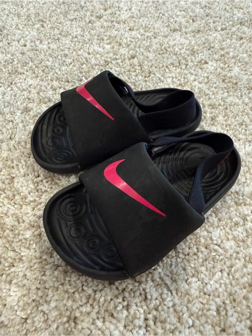 Nike Kids Black Slide Sandals with Pink Swoosh Accent